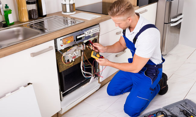 man fixing a dishwasher